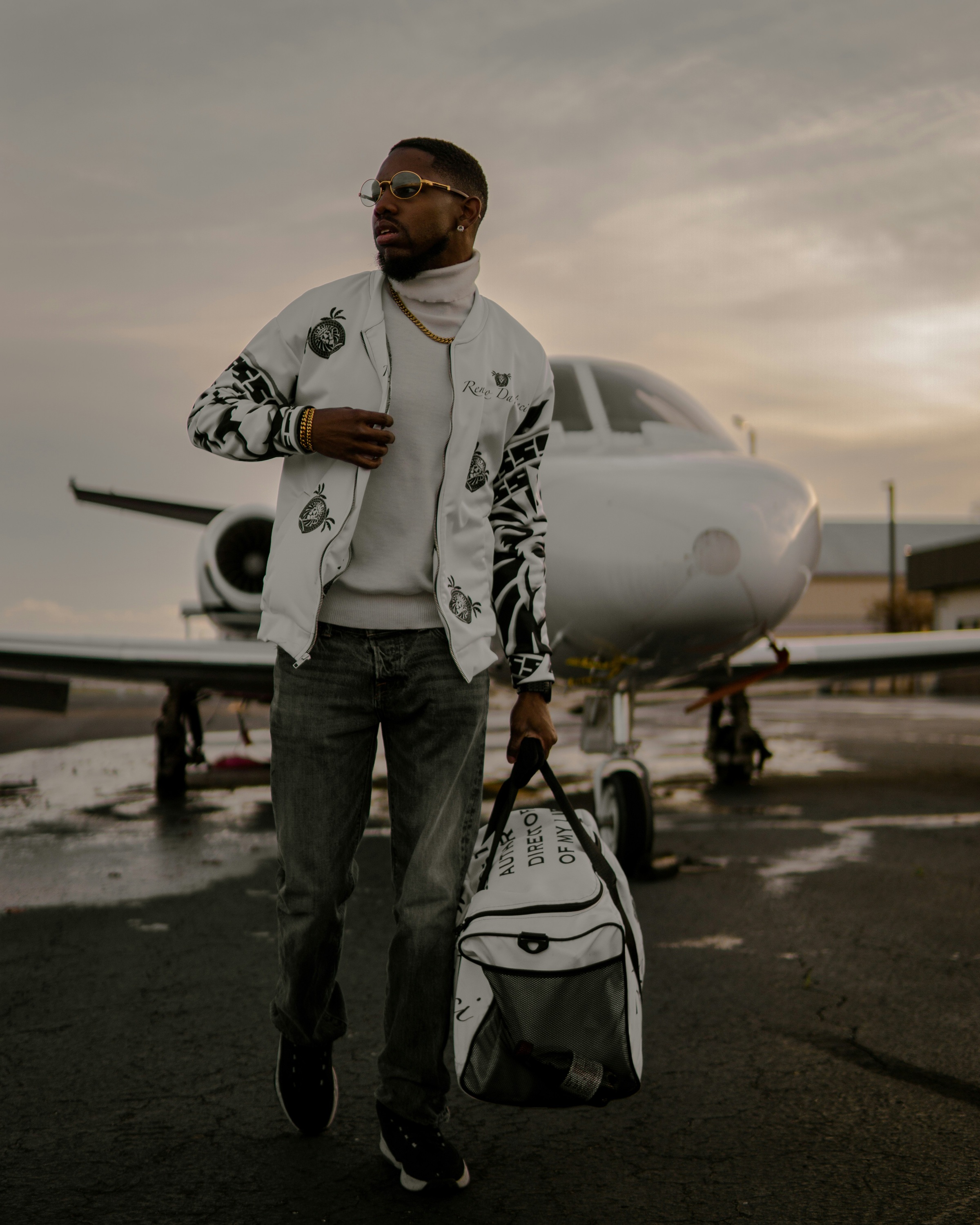 Traveller standing in front of a private jet before boarding
